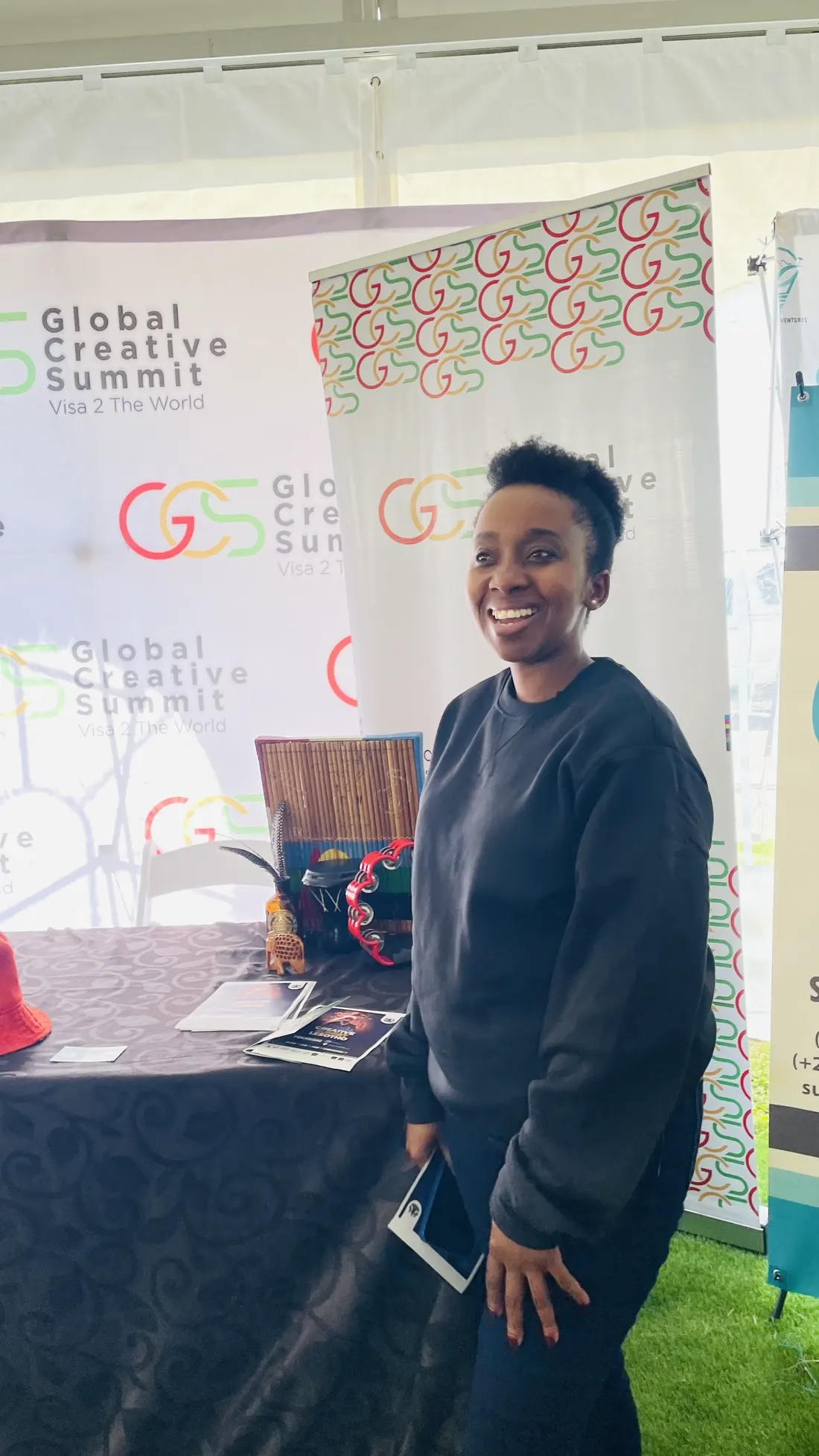 A delegate photographed at the Global Creative Summit banner in Lesotho