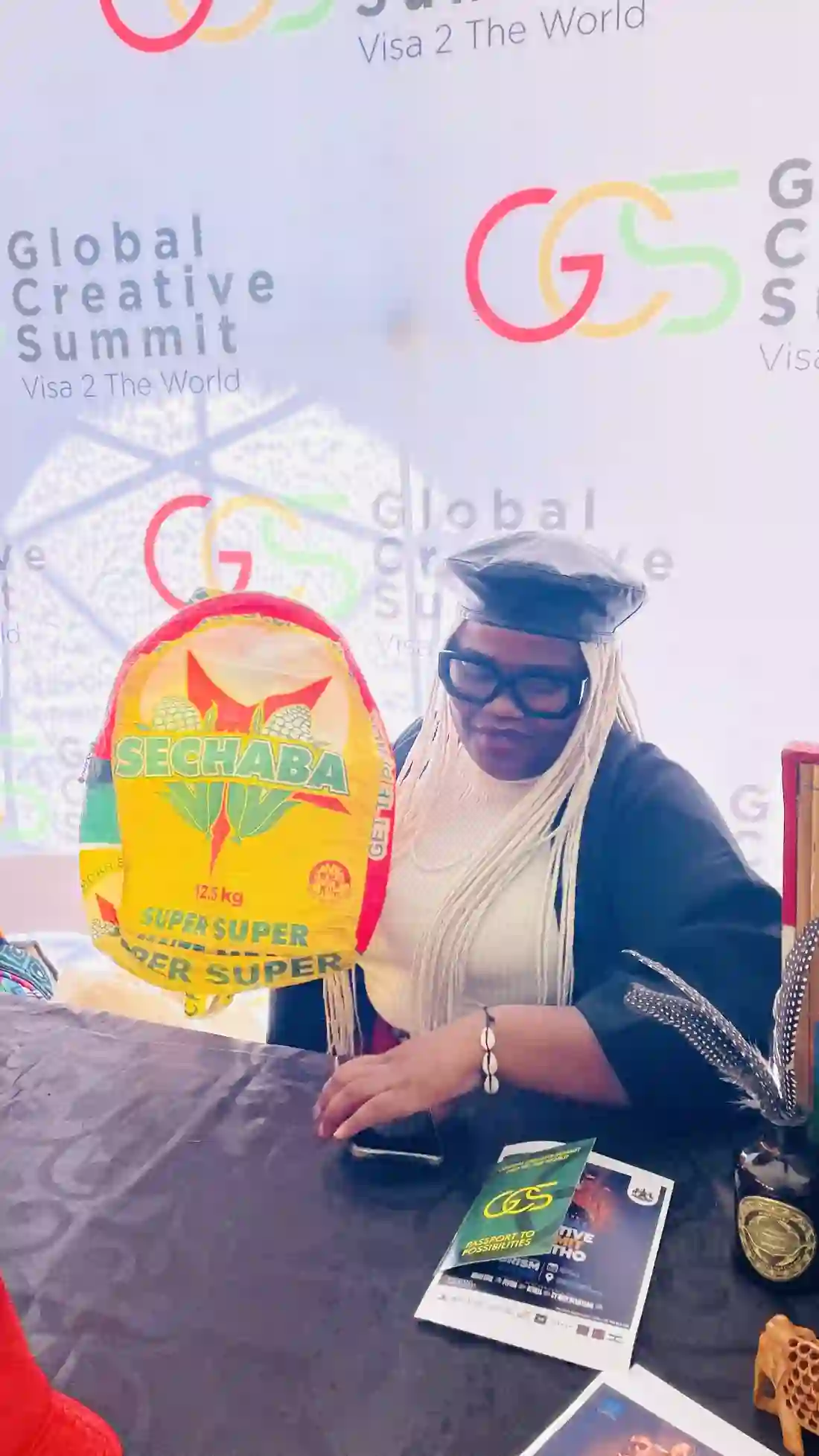 A delegate photographed at the Global Creative Summit backdrop in Lesotho