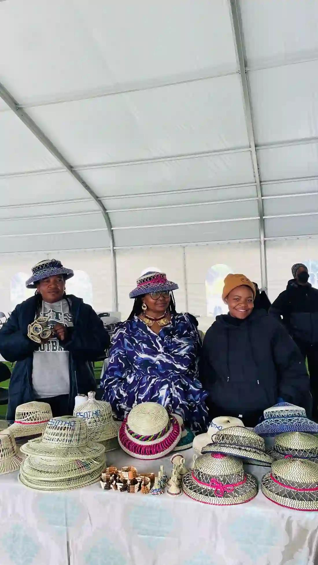 Lesotho makers displaying woven hats and basketry at the summit