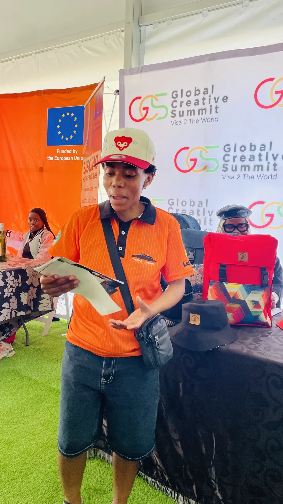 A visitor at the European Union stand beside the Global Creative Summit branding