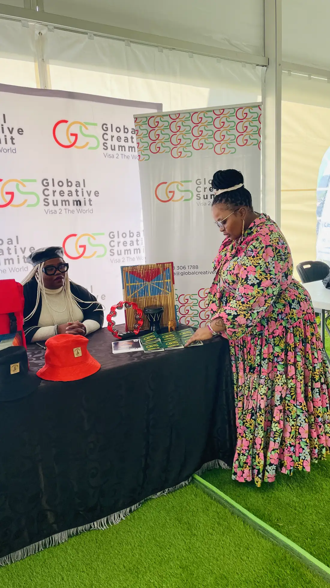 An exhibitor showing Basotho hats and craftwork at the Global Creative Summit stand
